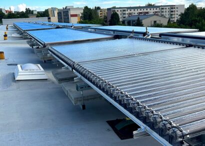 How to install solar thermal tube collectors on pitched flat roofs without penetrating the roof cladding?