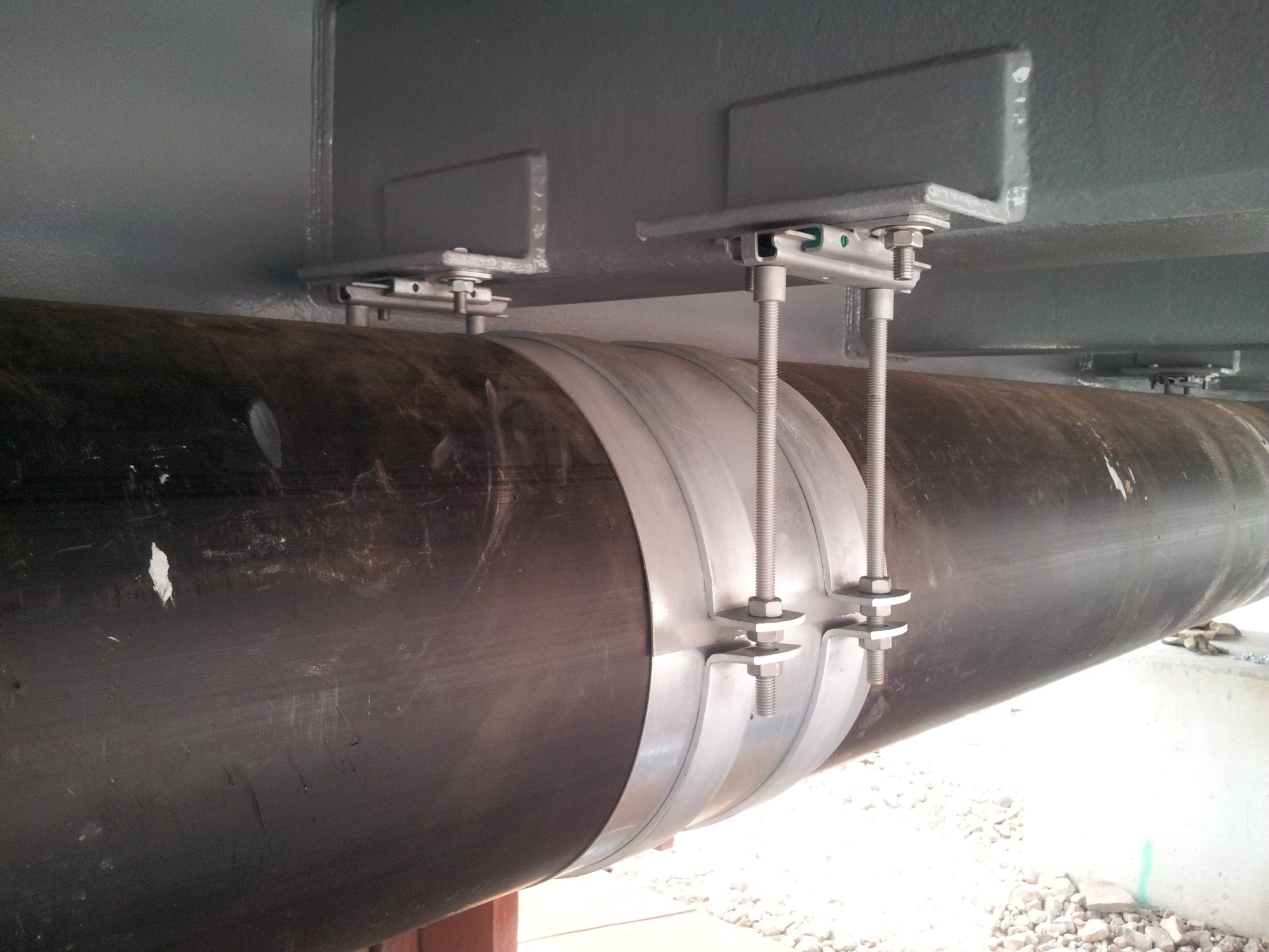 Heavy Duty Pipe Supports Complex Installation Under a Bridge